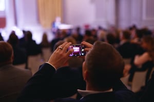 Person taking a picture at an event. 